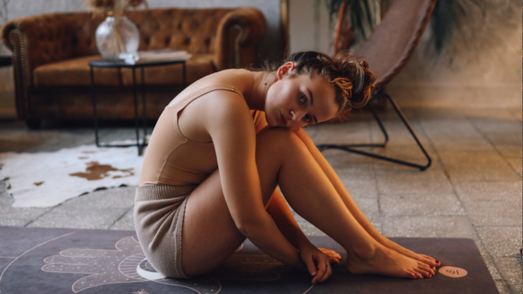 Photo of woman on yoga mat by KoolShooters