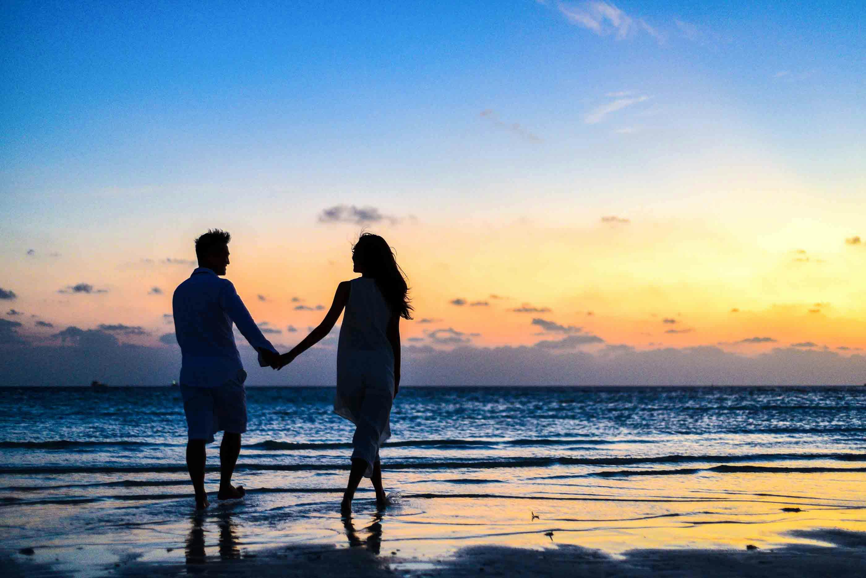 Photo of couple walking on the beach by Asad Photo Maldives